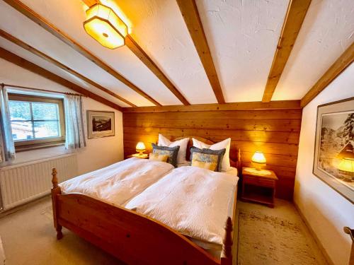 a bedroom with a bed with a wooden ceiling at Haus Annemarie in Oberndorf in Tirol