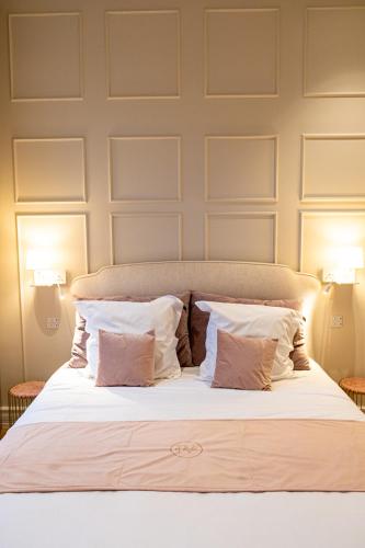 a bedroom with a bed with two pillows at St-Georges IV in Ypres