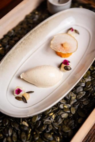 a white plate with a piece of food on a table at Landgasthof Zum Goldenen Anker in Eggenstein-Leopoldshafen