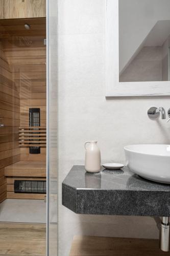 a bathroom with a sink and a mirror at Apartamenty Krokusowa Dolina in Kościelisko