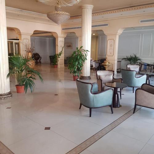 a lobby of a hotel with chairs and tables at فندق زهرة الخليج in Dammam