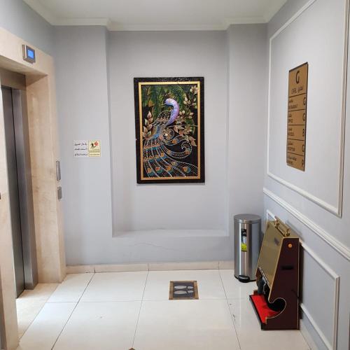 a room with a painting on the wall and a box on the floor at فندق زهرة الخليج in Dammam