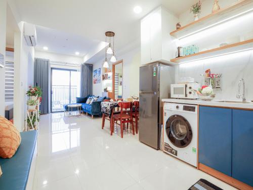 a kitchen and living room with a washing machine at May Soho Saigon Serviced Apartment in Ho Chi Minh City