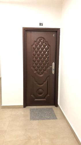 a brown door in a room with a tile floor at City hotel in Sibu
