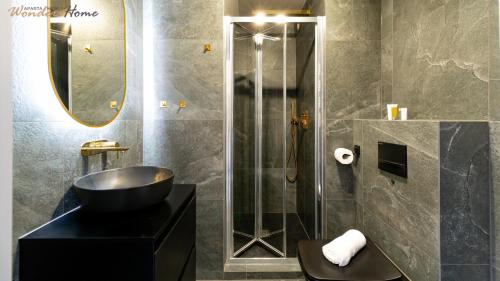 a bathroom with a black sink and a shower at Wonder Home - Apartamenty z widokiem na góry, blisko wyciągów, szlaków turystycznych i restauracji in Karpacz