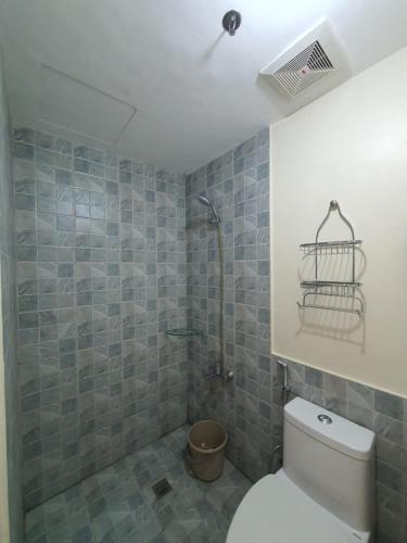 a bathroom with a toilet and a shower at Arlowes Cebu at 20f Grand Residences Cebu in Cebu City