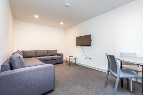 a living room with a couch and a table at Ensuite Room With Shared Kitchen, Close to Centre- 18 above in Lincoln
