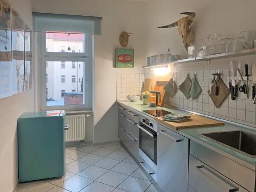 a kitchen with a sink and a stove top oven at Flemming in Leipzig