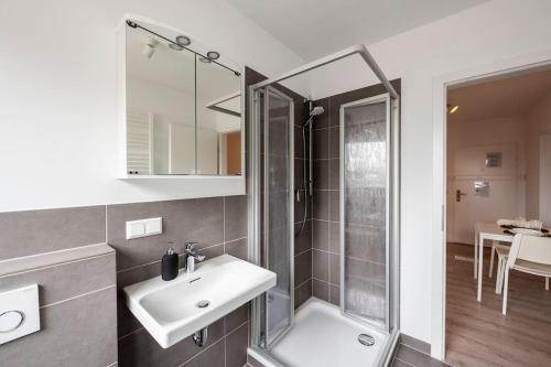 a bathroom with a sink and a shower at HA01 Großes Apartment am Hafen! in Worms