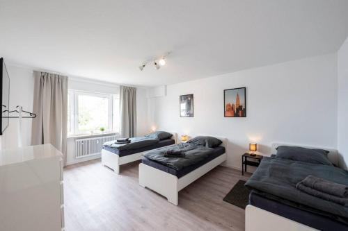 a living room with two beds and a couch at HA01 Großes Apartment am Hafen! in Worms