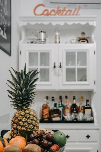 a pineapple in a bowl of fruit in a refrigerator at Imperial Rhome Guest House in Rome
