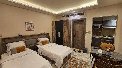 a hotel room with two beds and a kitchen at My Villa Hotel in Sheikh Zayed