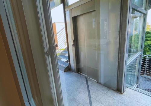 an open glass door to a balcony in a house at Belso in Rosate