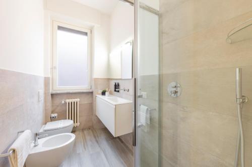 a bathroom with a toilet and a sink and a shower at Milan Royal Suites - Centro in Milan