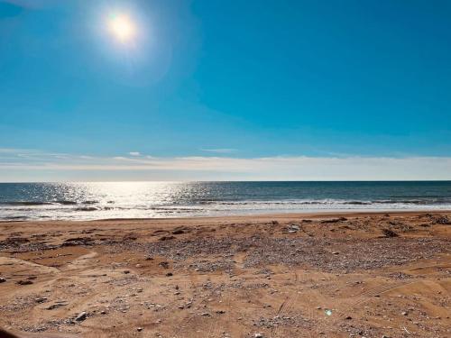 a sandy beach with the ocean in the background at Anesis Comfort Nature Living in Ladhikón