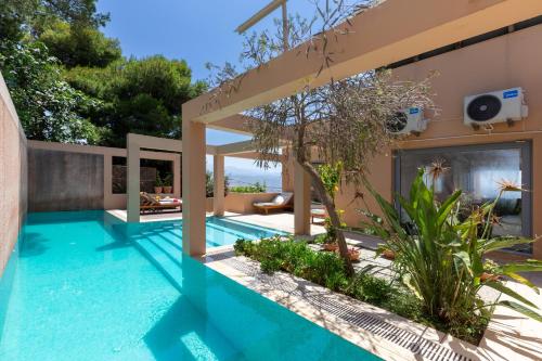 a swimming pool in the backyard of a house at Unlimited Blue in Chania