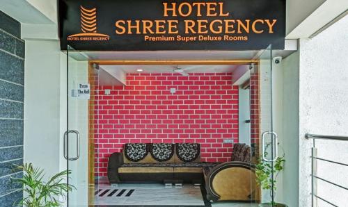 a store front with two benches in front of a brick wall at Hotel Shree Regency, Ahmedabad in Ahmedabad