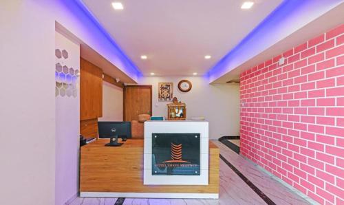 a room with a brick wall and a fireplace at Hotel Shree Regency, Ahmedabad in Ahmedabad