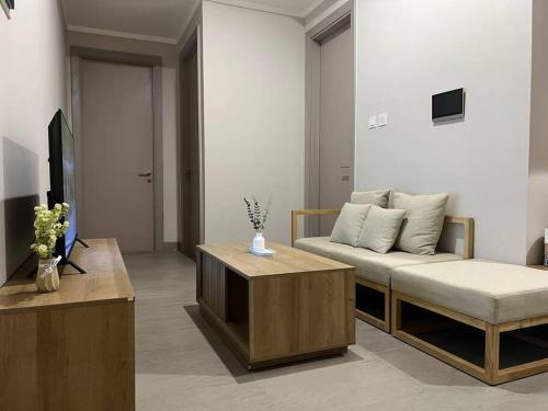 a living room with a couch and a coffee table at 2BR JIExpo Menara Jakarta (new) in Jakarta