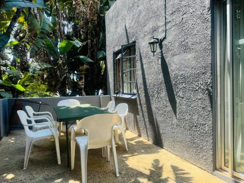 a table and chairs sitting next to a building at Busa House in White River