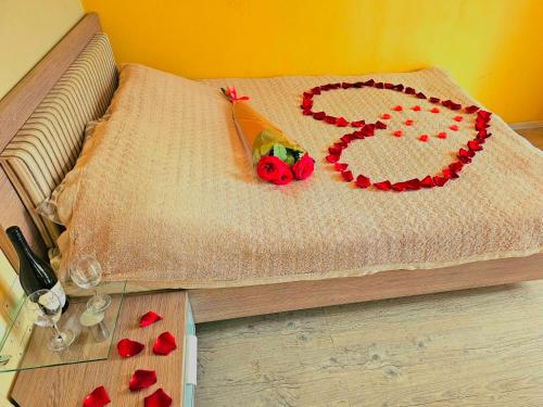 a cake with a number on a bed with hearts at Wonderful apartment on street Stefan cel mare 132 in Chişinău