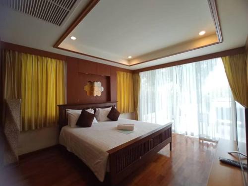 Postel nebo postele na pokoji v ubytování SeaRidge Hua Hin Resort & Poolvilla