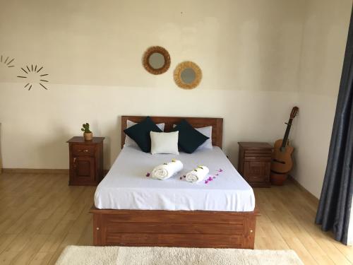 מיטה או מיטות בחדר ב-Sanda GuestHouse