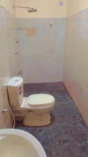 a bathroom with a toilet and a sink at Arana Holiday Resort in Kurundankulama