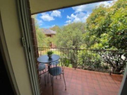 a view of a patio with a table on a balcony at Self contained 2 bedroom unit in Williamstown