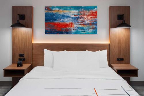 a bedroom with a white bed and two lamps at La Quinta Inn by Wyndham Wausau in Wausau