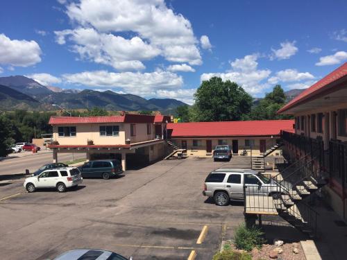 a parking lot with cars parked in front of a building at Garden of the Gods Motel in Colorado Springs