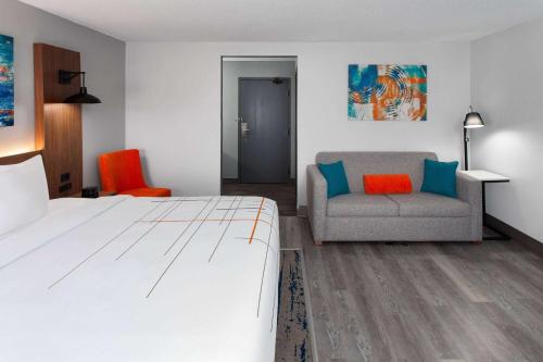 a hotel room with a bed and a chair at La Quinta Inn by Wyndham Wausau in Wausau