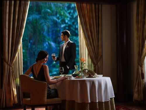a man and woman sitting at a table in a restaurant at Taj Krishna in Hyderabad