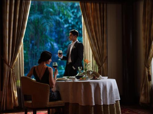 a man and a woman sitting at a table with wine glasses at Taj Krishna in Hyderabad