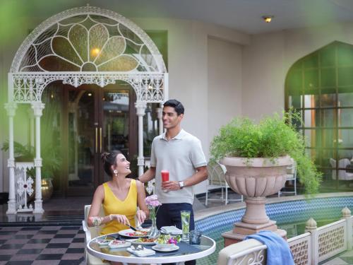 a man and a woman standing in front of a table at Taj Krishna in Hyderabad