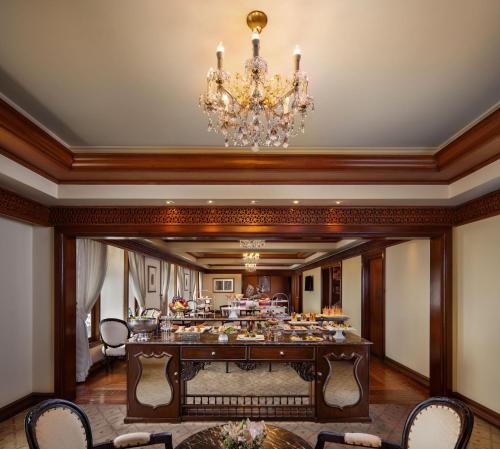 a large dining room with a chandelier at Taj Krishna in Hyderabad