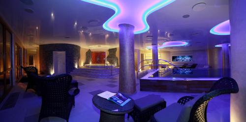 a room with a spa with a tub and chairs at Boutique Hotel Ambiente ****+ in Karlovy Vary