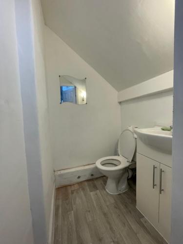 a bathroom with a toilet and a sink at Inviting 1-Bed Apartment in Leeds in Leeds