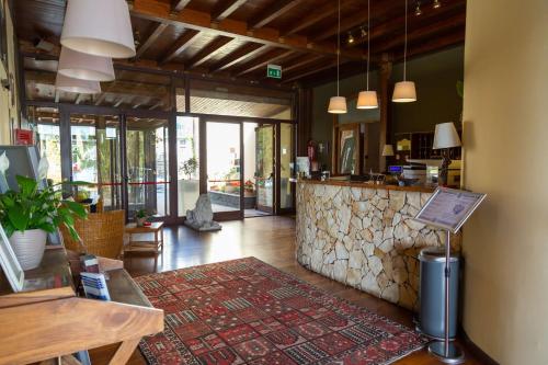 a restaurant with a bar with a stone counter at Best Western Hotel Santa Caterina in Acireale