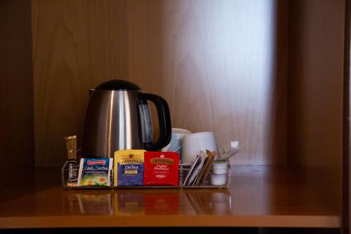 a coffee pot and other items on a table at Best Western Hotel Santa Caterina in Acireale