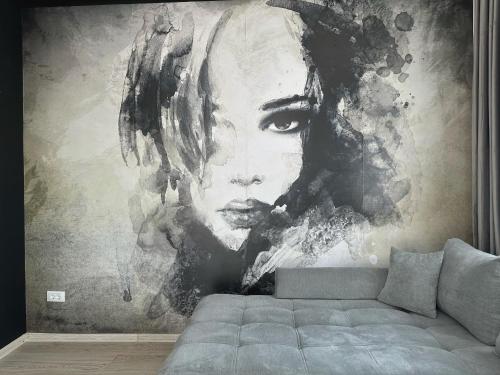 a large painting of a woman on a wall at KOA - Moon Penthouse in Braşov
