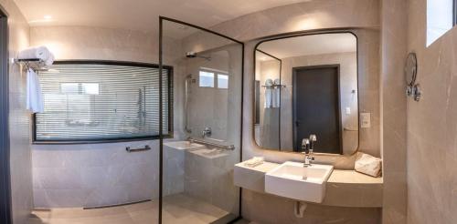 a bathroom with a sink and a mirror at HCM - Hotel Corais de Manaira in João Pessoa