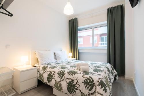a bedroom with a bed and a window at Moreira Terrace in Porto