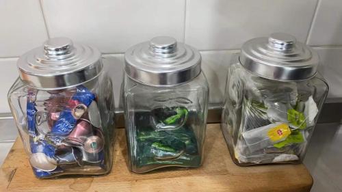 three glass jars with toys in them on a table at Doyles on the Bay in Kingscote