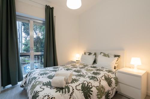 a bedroom with a bed and a window at Moreira Terrace in Porto