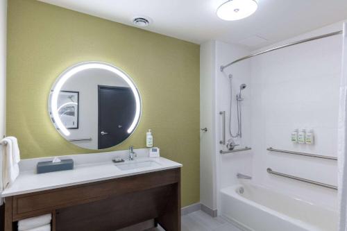 a bathroom with a sink and a mirror at La Quinta Inn & Suites by Wyndham Centralia in Centralia