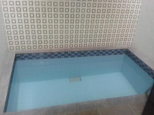 a bath tub sitting in a bath room next to a window at Motel Comodoro (Adult Only) in Rio de Janeiro