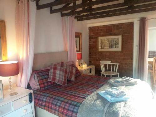 a bedroom with a bed with two towels on it at The Little House in Hull in Hull