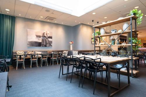 a restaurant with tables and chairs in a room at Best Western Plus Park City Solna in Solna
