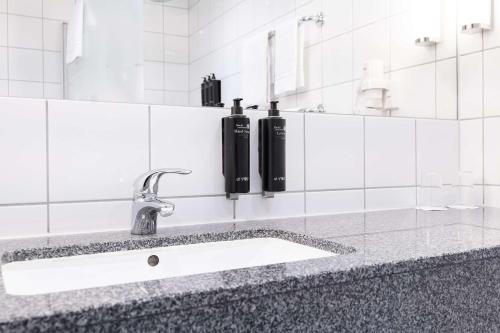 a bathroom counter with a sink and a mirror at Best Western Plus Park City Malmö in Malmö